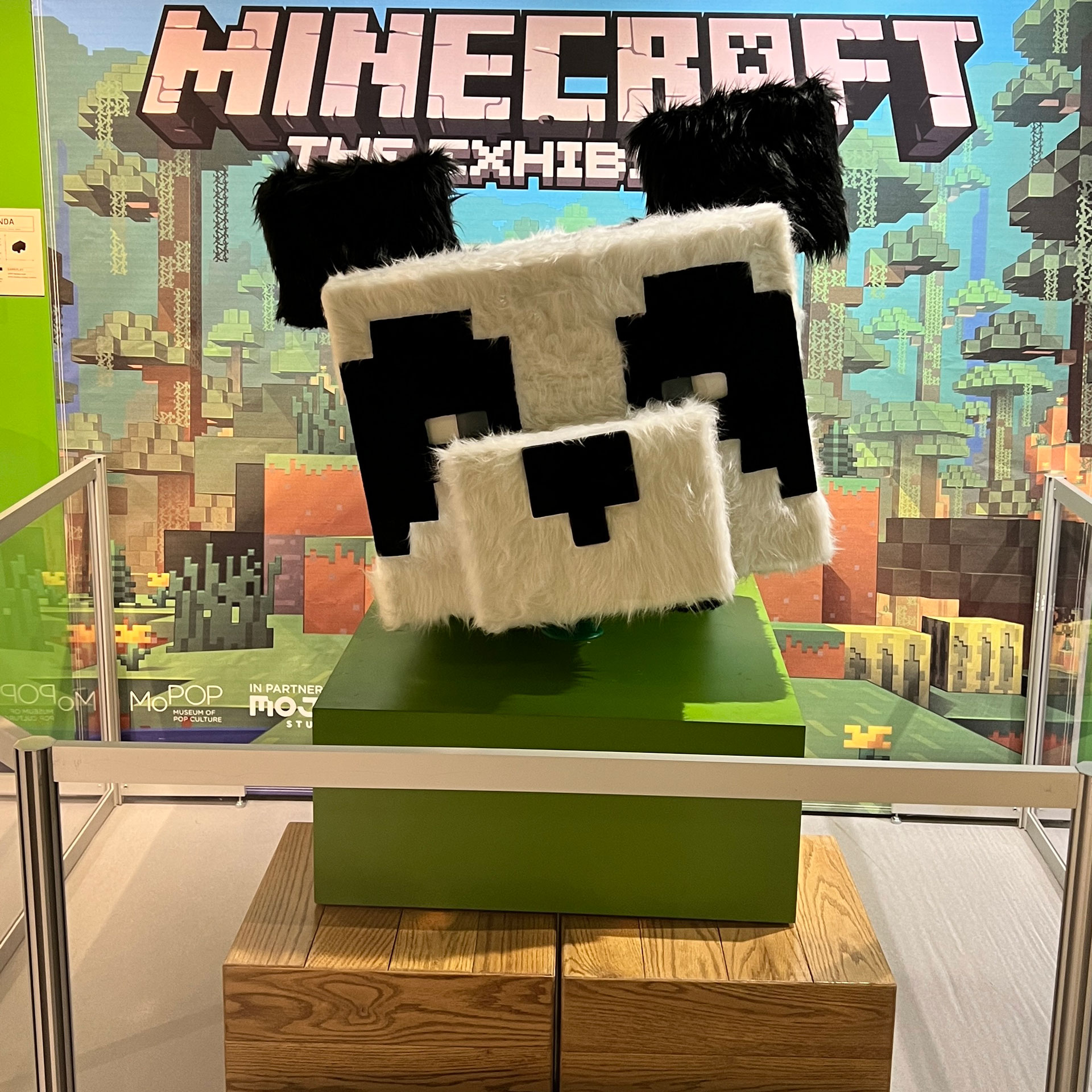 Life-sized Panda mob sculpture in front of a display of Minecraft merchandise in the Pixel8 Pop-Up Shop inside The Children's Museum Store.